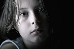 Sad child overcoming abuse